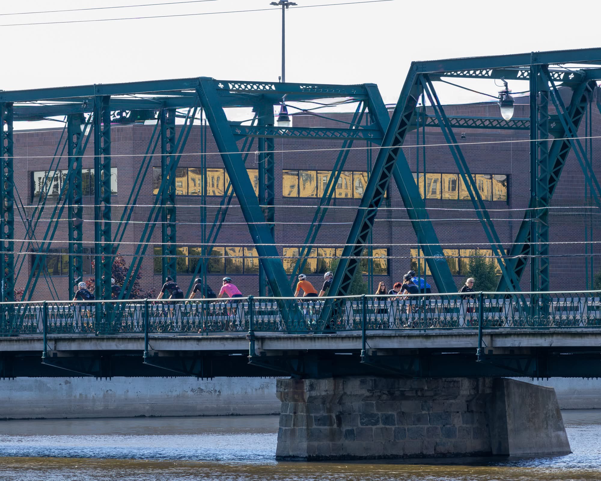 StellaFly group crossing the blue truss bridge on a ride