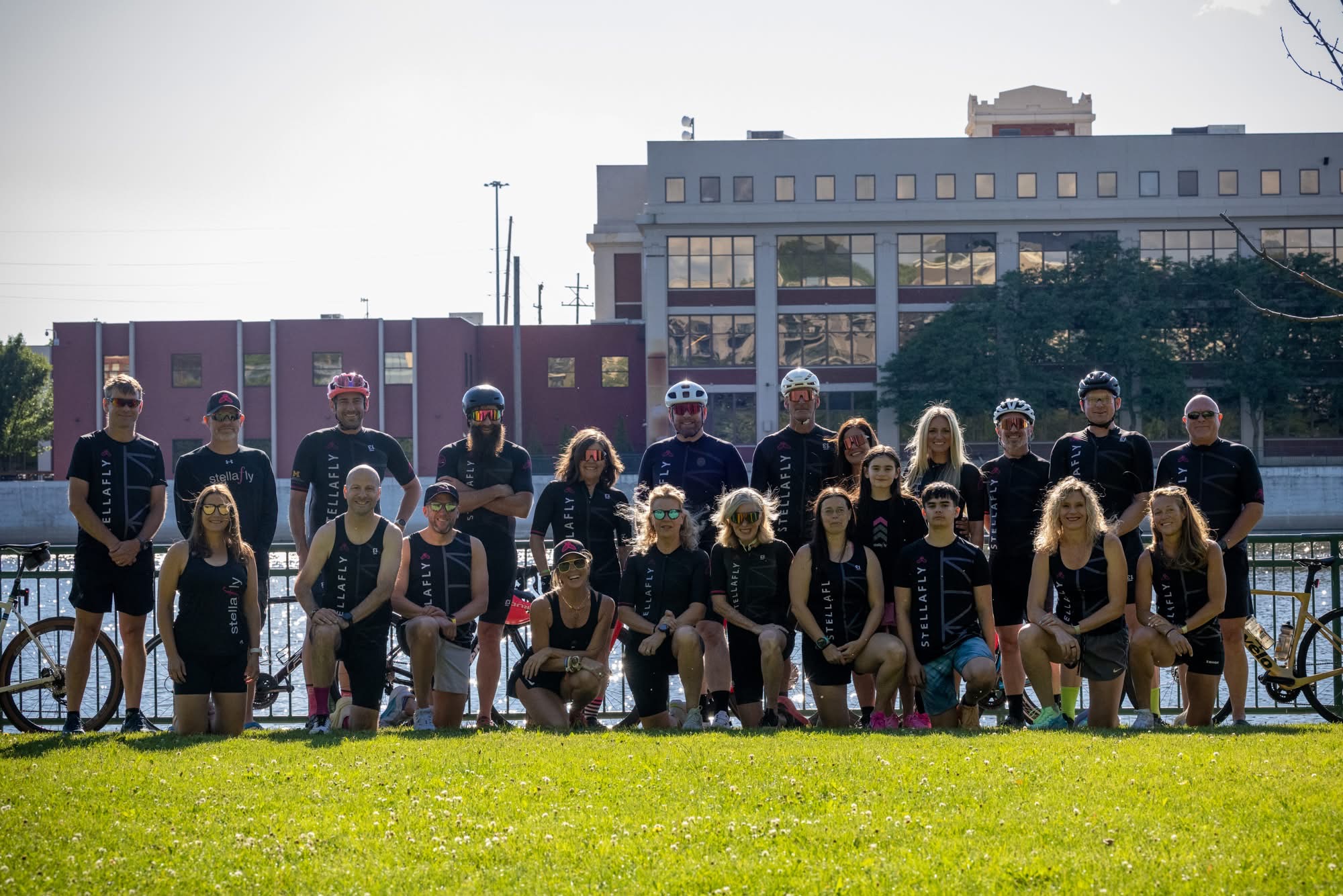 Team StellaFly athletes gathered together in kit along the river