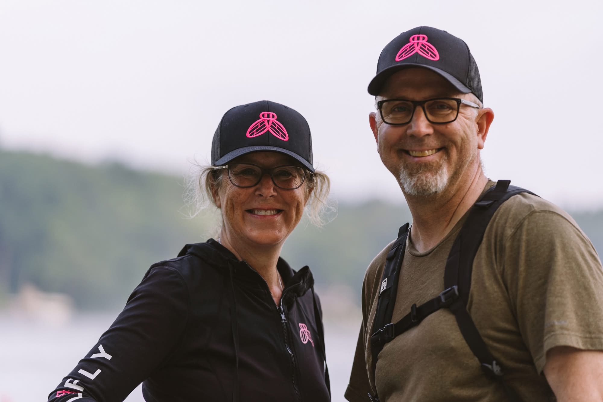 Two StellaFly teammates smiling by the water