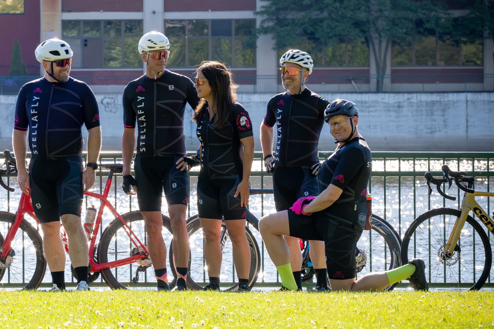 StellaFly riders talking and joking with bikes leaned against the rail